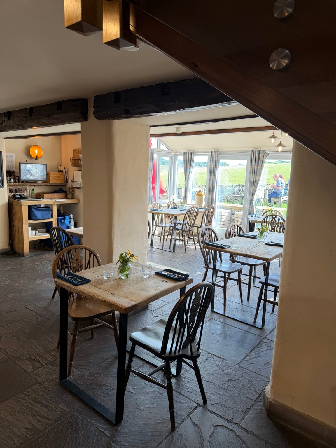 The dining room at the Blind Bull, opening into a conservatory with countryside views