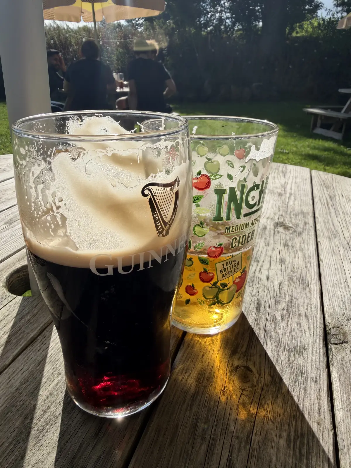 A pint of Guinness and a glass of cider in the sunny garden at The Jervis Arms in Onecote