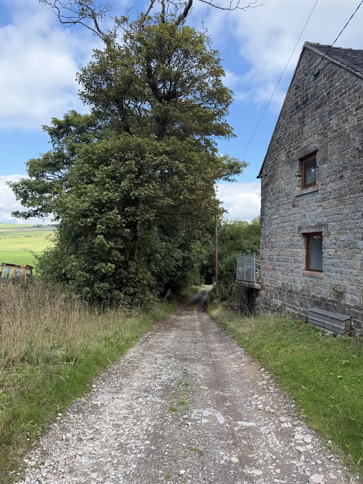 The stone track leading away from Lane Head Barns at the start of the walk