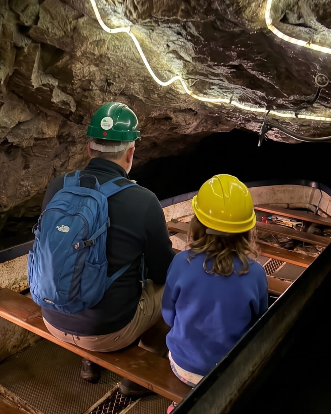 Ben and Alice on the boat, gliding through the tunnel inside Speedwell Cavern