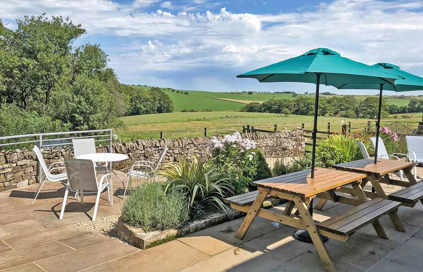 The terrace at Morridge View, with outdoor dining and views across farmland